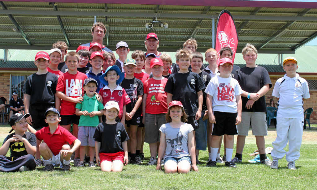 Warwick rugby union kids gather around Reds players Beau Robinson and David McDuling at the weekend. Warwick rugby union kids gather around Reds players Beau Robinson and David McDuling at the weekend.